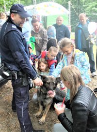 Policyjny pies służbowy wraz z przewodnikiem w towarzystwie dzieci