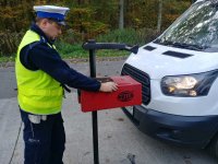policjant sprawdza światła w samochodzie